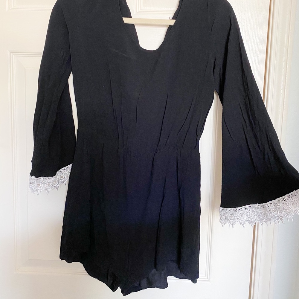 Black romper with lace detailed sleeves